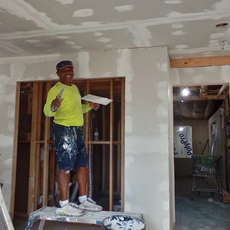 Jose finishing drywall on a room addition